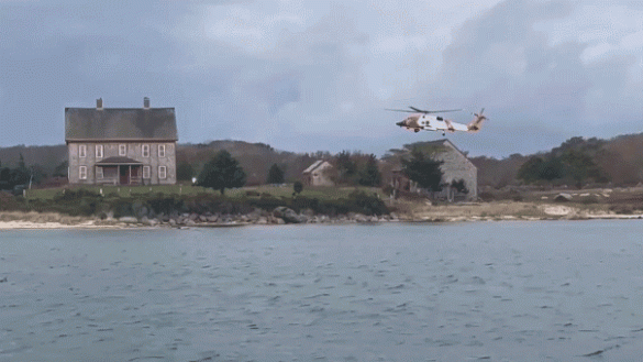 Woman dies after Coast Guard rescues family stranded on island fleeing boat fire